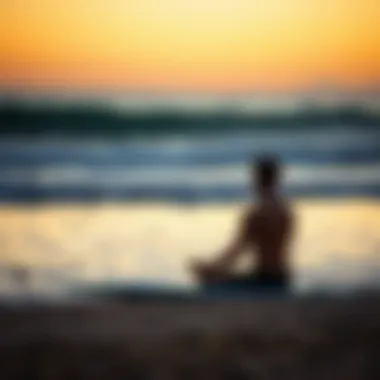Meditation and Mindfulness in Surfboarding Surfer meditating by the beach at sunrise