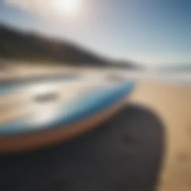 Surfboard resting on the sandy beach by the ocean