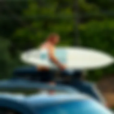 Surfer loading surfboard onto a vehicle with roof rack pads