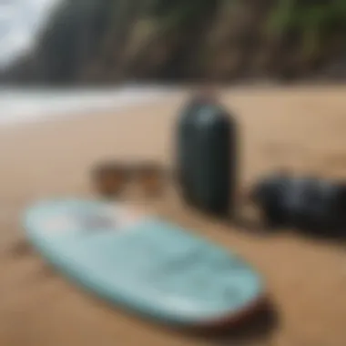 Essential surfing gear laid out on the sandy beach