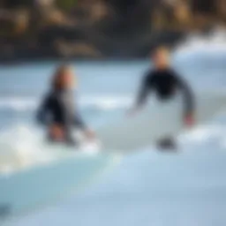 Surfing lesson with an instructor guiding a student on the beach