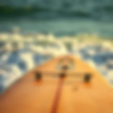 Close-up of a well-maintained surfboard against the backdrop of the waves