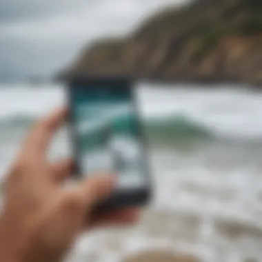 A surfer checking wave conditions using a mobile app on the beach