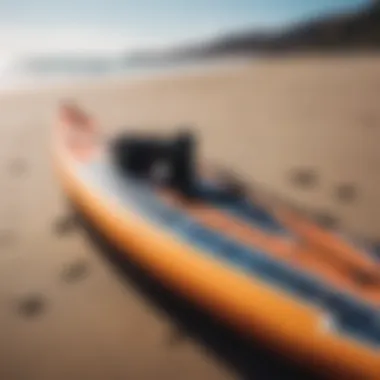 A close-up of essential kite surfing gear laid out on the beach, including a kite and board.