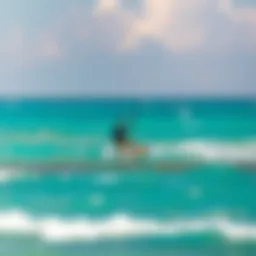 Kiteboarder gliding over turquoise waters
