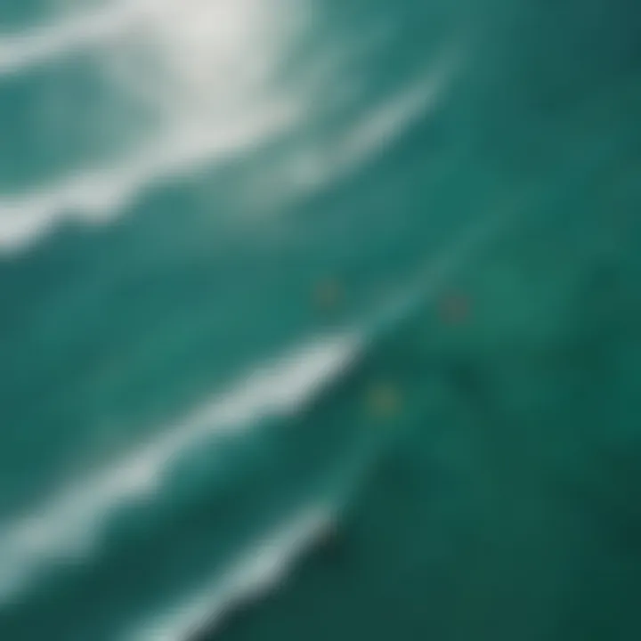 An aerial shot of colorful kites soaring over turquoise waters