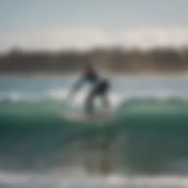 A beginner surfer practicing balance on a surfboard in gentle waves