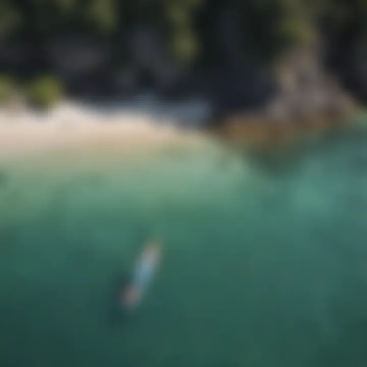 An aerial view of a paddleboarder exploring a coastal environment