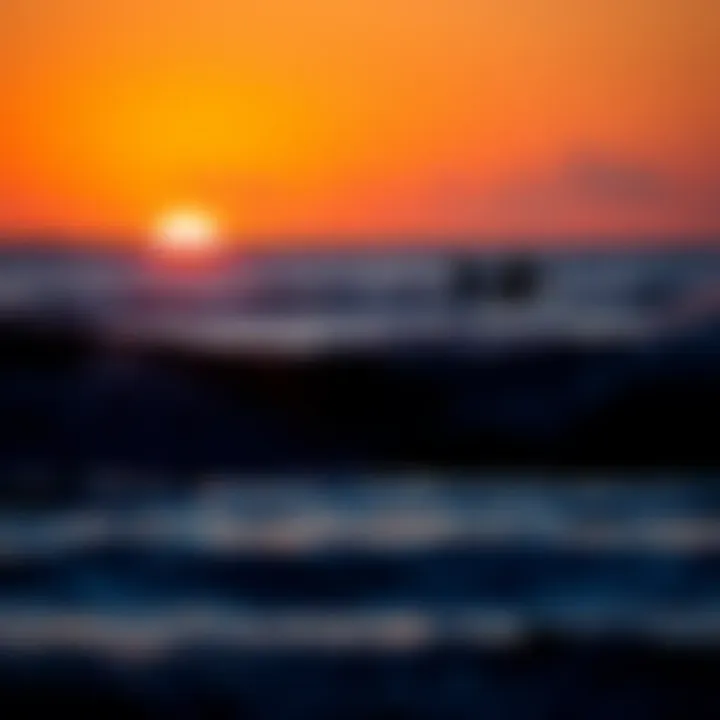 A picturesque sunset over the ocean with surfers in silhouette