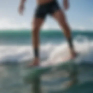 Surfer wearing a shark deterrent ankle band while enjoying ocean waves.